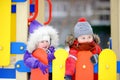 Little boy and girl in winter clothes having fun in outdoors playground Royalty Free Stock Photo