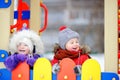 Little boy and girl in winter clothes having fun in outdoors playground Royalty Free Stock Photo