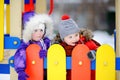 Little boy and girl in winter clothes having fun in outdoors playground Royalty Free Stock Photo