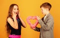 Little boy give pink heart to girl. Valentines day. Holiday celebration. First love. Be my Valentine. Love my Valentine