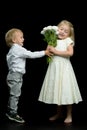 A little boy gives a girl a bouquet of flowers. The concept of l Royalty Free Stock Photo