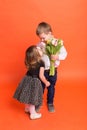 Little boy gives a girl a bouquet of flowers