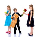 A little boy gives the girl flowers. Royalty Free Stock Photo