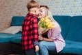 a little boy gives his mother flowers .mother& x27;s day concept Royalty Free Stock Photo