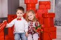 Little boy giving a red flower to a beautiful smiling little girl. Royalty Free Stock Photo