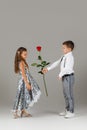 Little boy giving a red rose to child girl Royalty Free Stock Photo