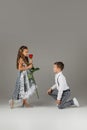 Little boy giving a red rose to child girl Royalty Free Stock Photo