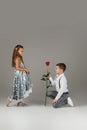 Little boy giving a red rose to child girl Royalty Free Stock Photo