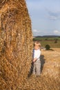 Little boy on goden hay field