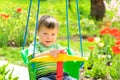 little boy goes for a drive on a swing