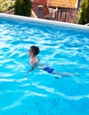 Little boy swim breaststroke in swimming pool