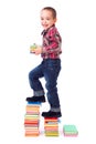 Little boy going up stairs made of books