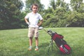 Little boy golfer with his golf bag on the fairway Royalty Free Stock Photo