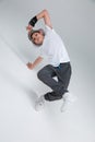 A little boy, in good physical condition, stands on the bridge, throwing his foot on leg and holding hand near the head. Royalty Free Stock Photo