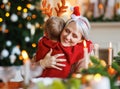 Little boy grandson embracing happy smiling grandmother during Christmas dinner at home