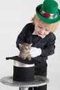 Little boy in a green hat and bow tie kitty gets Royalty Free Stock Photo