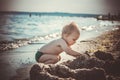 Little boy in green shorts played on the beach Royalty Free Stock Photo
