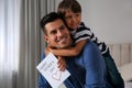 Little boy greeting his dad with Father`s Day at home Royalty Free Stock Photo