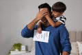 Little boy greeting his dad with Father`s Day at home Royalty Free Stock Photo