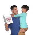 Little boy greeting his dad with Father`s Day on white background Royalty Free Stock Photo