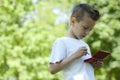 Little boy with handheld videogame outdoors