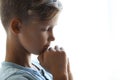 Little boy with hands clasped together for prayer on light background. Royalty Free Stock Photo