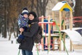 The little boy in the hands of his father in the winter weather. Walk in the Park in the snow.