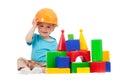 Little boy with hard hat and building blocks
