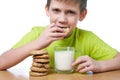 Little boy has breakfast cookies and milk isolated Royalty Free Stock Photo