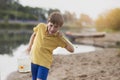 A little boy has caught a goldfish and is carrying it in a glass jar