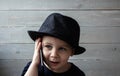 A little boy in a hat holds a phone Royalty Free Stock Photo