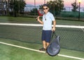 Little boy with hat and racket in his shoulder after a night ten Royalty Free Stock Photo