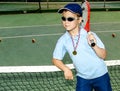 Little boy with hat and racket in his shoulder after a night ten Royalty Free Stock Photo