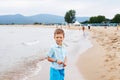 Little boy having fun on tropical ocean beach. Kid during family sea vacation. Summer water fun. Royalty Free Stock Photo