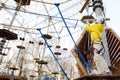 Little boy having fun in Adventure Park for children amoung ropes, stairs, bridges. Outdoor climbing adventure playground in