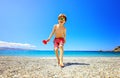 Little boy having fun at the beach on vacation. Kid wearing sunglasses and smiling running towards the camera