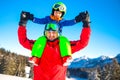 Little boy having fun with his caucasian attractive father during skiing in Alps.