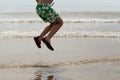 Little boy having fun jumping on the beach at the day time Royalty Free Stock Photo
