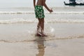 Little boy having fun jumping on the beach at the day time Royalty Free Stock Photo