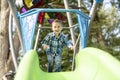 Little boy having fun on a playground outdoors in summer. Toddler on a slide. Royalty Free Stock Photo