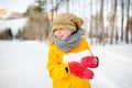 Little boy having fun playing with icicle or snowball in forest on sunny winter day. Active outdoors leisure for child on nature Royalty Free Stock Photo