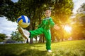 Little boy having fun playing soccer with ball