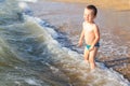 A little boy having fun in the sea on the waves Royalty Free Stock Photo