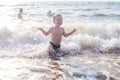 A little boy having fun in the sea on the waves Royalty Free Stock Photo