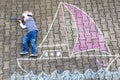 Little boy having fun with ship picture drawing with chalk Royalty Free Stock Photo