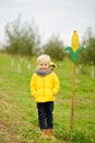 Little boy having fun on a tour of a pumpkin and corn farm at autumn. Kid standing near sign of corn maze traditional american Royalty Free Stock Photo