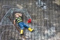 Little boy having fun with tractor picture drawing with chalk Royalty Free Stock Photo