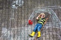 Little boy having fun with tractor picture drawing with chalk Royalty Free Stock Photo