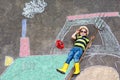 Little boy having fun with tractor picture drawing with chalk Royalty Free Stock Photo