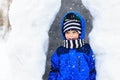 Little boy having fun in winter snow cave